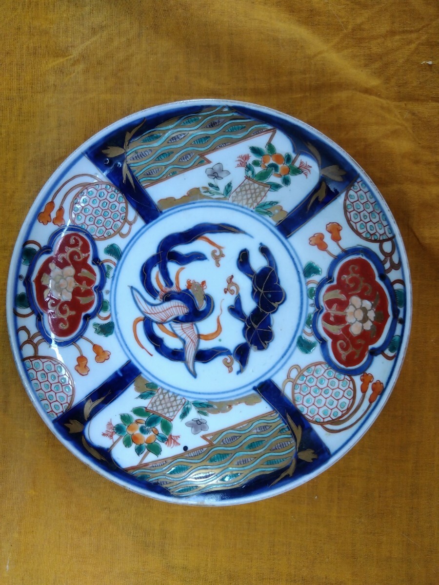Antique Japanese tableware with painted designs.