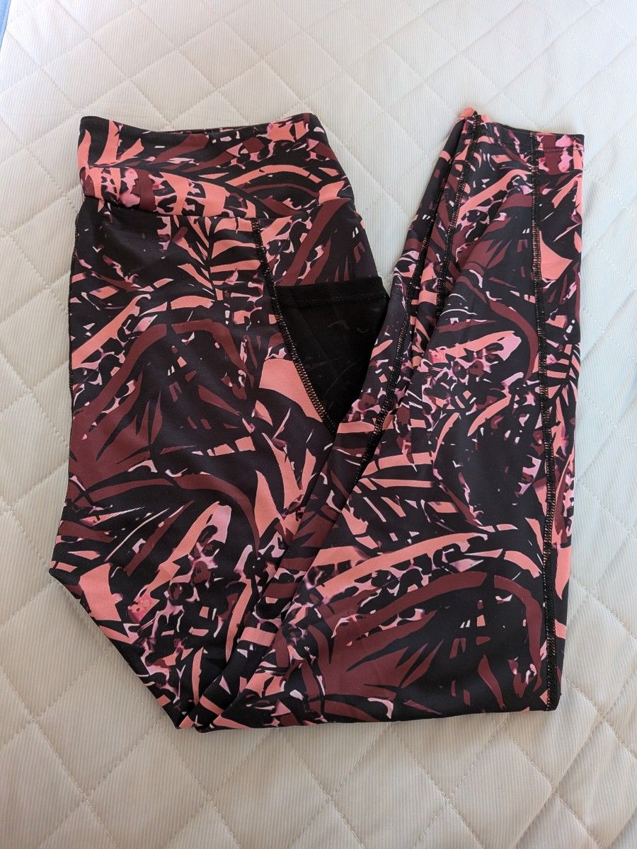 Black nylon tank top with all-over botanical print fitness and yoga wear.